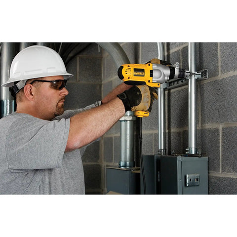 Man using Corded Hammer Drill Kit With Half Inch Capacity And Ten Amp Power For Masonry Wood And Steel Drilling Dual Mode Hammer