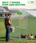 Man feeding chickens in Walk In Metal Chicken Coop With Run For Yard, Weatherproof Spire Roof Cage with UV cover, split doors visible.