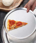 Pro Grade Restaurant Aluminum Pizza Pan 14-Inch Coupe Style Baking Tray Pack Of 6 with pizza slice on pan in use