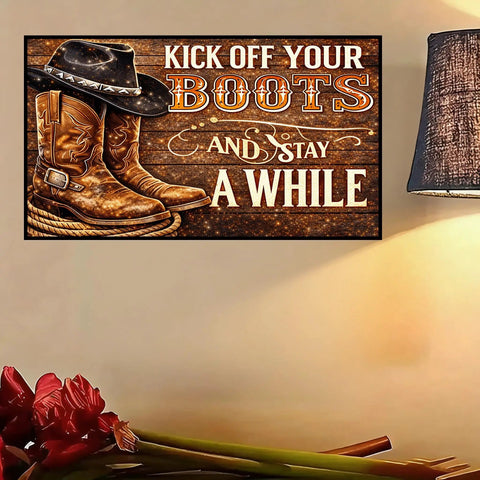 Decorative sign reading 'Kick Off Your Boots and Stay A While' with cowboy boots and hat next to a lamp and flowers.