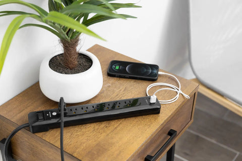 Dope UltraPro 7 Outlet Surge Protector With USB Ports on wooden table near plant, 4 foot cord visible