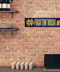 Notre Dame Fighting Irish 16 Inch Plastic Street Sign Wall Decor Legit Game Day Essentials Tailgate Ready College Football Fan Gear With Vivid Team Logo And Easy Mounts For Quick Setup on brick wall.