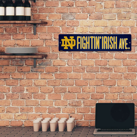 Notre Dame Fighting Irish 16 Inch Plastic Street Sign Wall Decor Legit Game Day Essentials Tailgate Ready College Football Fan Gear With Vivid Team Logo And Easy Mounts For Quick Setup on brick wall.