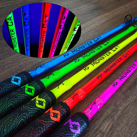 Various colored glow-in-the-dark fishing rods, featuring the Beast Catfish Rod, 7 Ft, Medium Heavy, One Piece with durable EVA foam grips.
