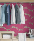 Dope Pink Leaping Cheetah Peel And Stick Wallpaper Self Adhesive Wall Covering For Bedrooms And Living Rooms Removable Contact Paper No Residue Easy To Reposition in a closet setting with hanging clothes.
