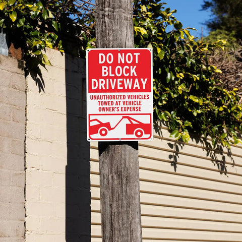 No Messing Around Heavy Duty Do Not Block Driveway Sign 14 By 10 Inches Rust Proof Aluminum on a wooden pole outdoors.