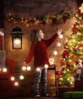 Child decorating Christmas tree near dusk to dawn outdoor light with GFCI outlet and dual receptacles, cozy room setting