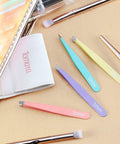 Pro Grade Eyebrow Tweezer Set Four Piece Slant And Pointed Tips Stainless Steel Multi Color displayed with accessories