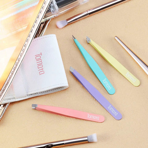 Pro Grade Eyebrow Tweezer Set Four Piece Slant And Pointed Tips Stainless Steel Multi Color displayed with accessories