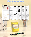 Hassle Free Bluetooth Label Maker With Straightforward Phone Sync And One Included Thermal Tape Roll Sweet For Quick Diy Crafting And Super Clean Home Tagging In Bright Yellow on a desk with smartphone displaying app.