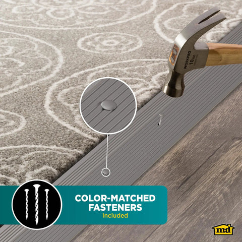 Pewter Aluminum Carpet Trim 2 In By 36 In With Screw Nails, Strong Transition Strip For Doorways And Uneven Floors, Durable Aluminum That Is Built For High Traffic, Pre Drilled Holes For Quick Easy Install shown with hammer and carpet application