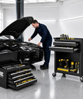 Man working on car with Smooth Rolling 8 Drawer Tool Chest With Nifty Detachable Modular Layout And Secure Locking Drawers For Top Shelf Garage Storage Slick Black Finish in garage.