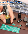 Close-up of hand using All In One Leather Punch Kit With 52 Shape Punch Cutters, cutting shapes on leather with cutting mat.