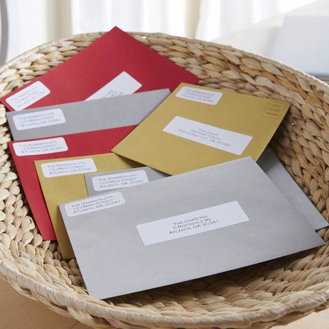 No Sweat White Mailing Address Labels For Slick Office Packing on colorful envelopes in woven basket for shipping organization.