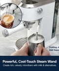 Compact Espresso And Cold Brew Coffee Maker Featuring Built In Milk Frother Wand creating microfoam in jug.