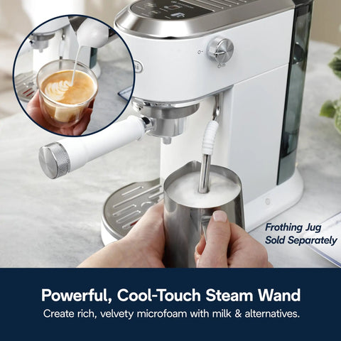 Compact Espresso And Cold Brew Coffee Maker Featuring Built In Milk Frother Wand creating microfoam in jug.
