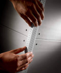 Hands applying paper corner bead with Drywall corner bead spray adhesive 13.8 oz can, contractor-grade fast-grab aerosol.