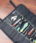 Open black tool roll with assorted tools inside, not a Portable Canvas Knife Roll Bag For Chef Knives And Cutlery