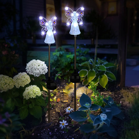 Solar Angel Garden Stake Lights 2 Pack With 7 LEDs illuminating garden at night, featuring stainless steel angel figures among flowers.