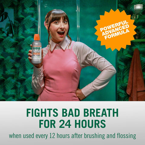 Person holding Fresh Breath Mouthwash With OXYD8 And Zinc Gluconate To Knock Out Bad Breath, Peppermint Flavor in pink outfit