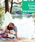 Couple sitting under Travel Clothesline With 12 Colorful Clips And Waterproof Bag, ideal for camping and outdoor use, near a lake.