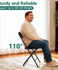 Man sitting on 4 Pack Black Plastic Folding Chairs With Steel Frame For Outdoor Use No Fuss Portable Stackable Foldable Seating 350 Lb Capacity