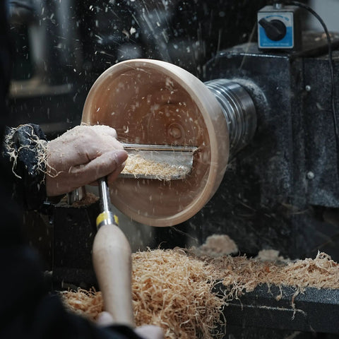 Heavy Duty 1 Inch Diameter Woodturning Lathe Tool Rest Set in use, shaping a wooden bowl with shavings flying.