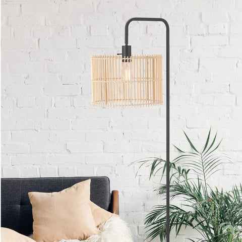 58 Inch Matte Black Floor Lamp With Bamboo Shade That Peeks Through in cozy living room corner with plants and sofa