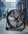 Industrial Drum Fan 8100 CFM High Velocity, Heavy Duty Tilt-Head Metal Shop Fan in warehouse setting