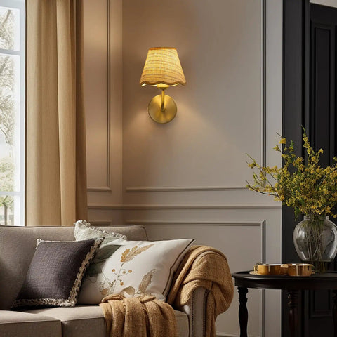 PENACINY Battery Operated Rattan Wall Sconces Set of 2 mounted on wall beside a cozy sofa with decorative pillows.