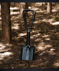 Beast Survival Folding Camp Shovel With Pickaxe Tri Fold Tactical Entrenching Tool in forest setting, manganese steel