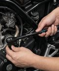 Work Horse 3/8 Inch Drive Ratchet Wrench With Extra Long Handle And 90 Tooth Gearing used for motorcycle repair, showing hand applying torque.