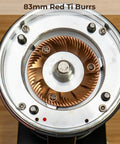 Close-up of 83mm red titanium burrs in Top Shelf Single Dose Coffee Grinder equipped with integrated plasma ionizer chute.