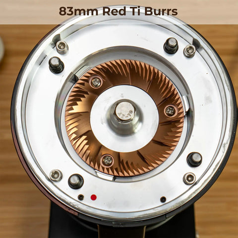 Close-up of 83mm red titanium burrs in Top Shelf Single Dose Coffee Grinder equipped with integrated plasma ionizer chute.