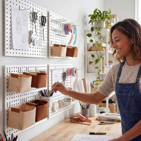Metal Pegboard Organizer Set 4 Pack White Wall Pegboards With 50 Hooks And Baskets Built Tough For Office Craft Room Garage Sewing Room 300 Lb Capacity Rust Free No Sag Mounting System shown in a craft room.