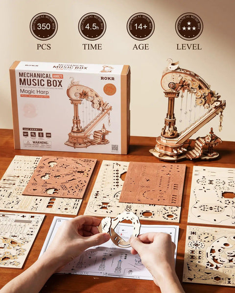 3D Wooden Harp Music Box Kit For Adults partially assembled, showing components and packaging on a table.