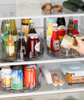 Fridge Spice Lazy Susan Organizer With 360 Degree Rotation holding condiments and sauces on clear PET turntable in fridge.