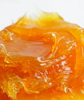 Close-up of amber-colored grease used with the All In One Grease Fitting Tool For 1/8 And 7/16 NPT.