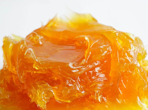 Close-up of amber-colored grease used with the All In One Grease Fitting Tool For 1/8 And 7/16 NPT.