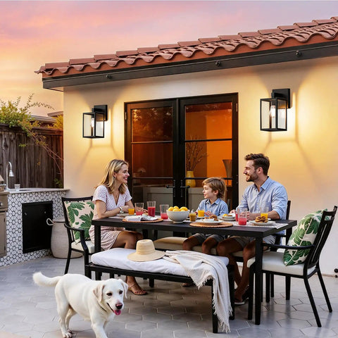 Built Tough Black Outdoor Wall Lantern With Waterproof Exterior Sconce, mounted beside a family enjoying dinner outdoors.