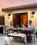 Bulletproof Black Outdoor Wall Light Fixtures Weather Resistant Porch Sconces illuminate a family dinner on a patio.