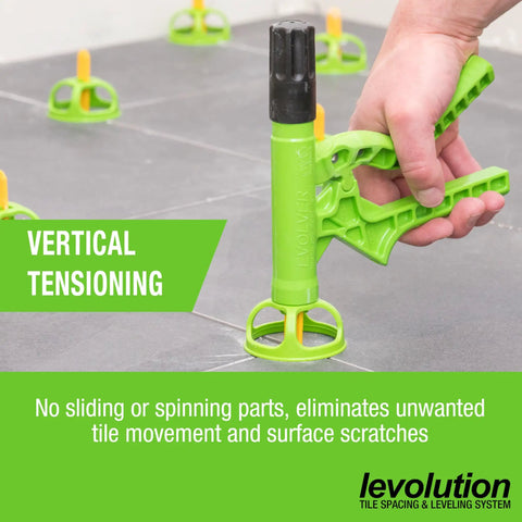 Green Evolver Tensioning Tool For Tile Leveling And Spacing System Lippage Control with ergonomic trigger on gray tiles.