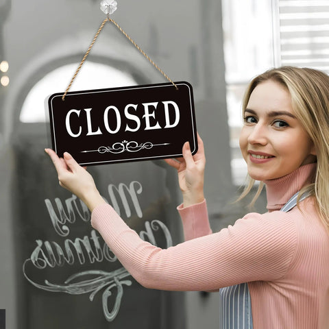 Woman holding Open Closed Sign For Biz 12x6.7 Inches Waterproof Double Sided Hanging Sign That Says Come In Or Closed With Hours Flip