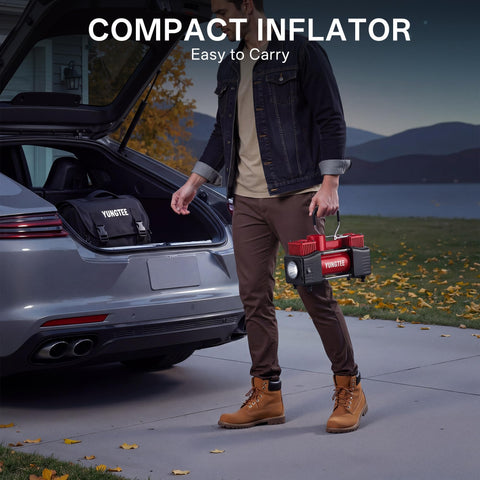 Man carrying Beefy 12V Double Cylinder Tire Inflator with car trunk open, showcasing easy portability for road use.