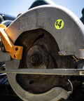 Close-up of a circular saw with a $4 price sticker attached.