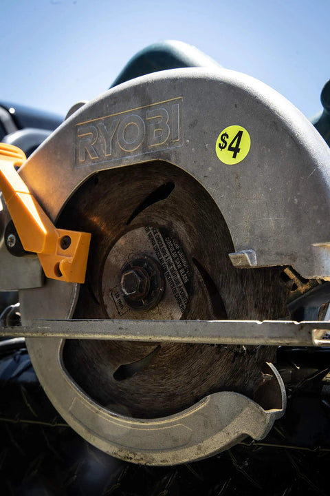 Close-up of a circular saw with a $4 price sticker attached.