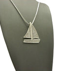 Iced Out Sailing Yacht Pendant Necklace With 24 Inch Chains In Silver Tone, Choose 2mm Box Chain, 3mm Cuban Chain, Or 2mm Rope Chain, 1.25 By 1.65 Inch Pendant, Imitation Silver Plated Fashion Jewelry displayed on a mannequin