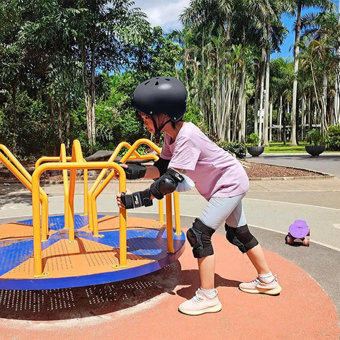 Child wearing All Ages Skating Protective Gear Set With Helmet Knee Pads Elbow Pads And Wrist Guards for safety outdoors.