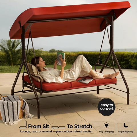 Three Seat Patio Swing With Canopy For Backyard Or Porch Convertible Glider Bed in Burgundy with woman lounging on it