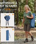 Woman carrying Heavy Duty Portable Camping Chair with 350 lb capacity in blue bag, shown folded and ready for transport, for fishing and camping.